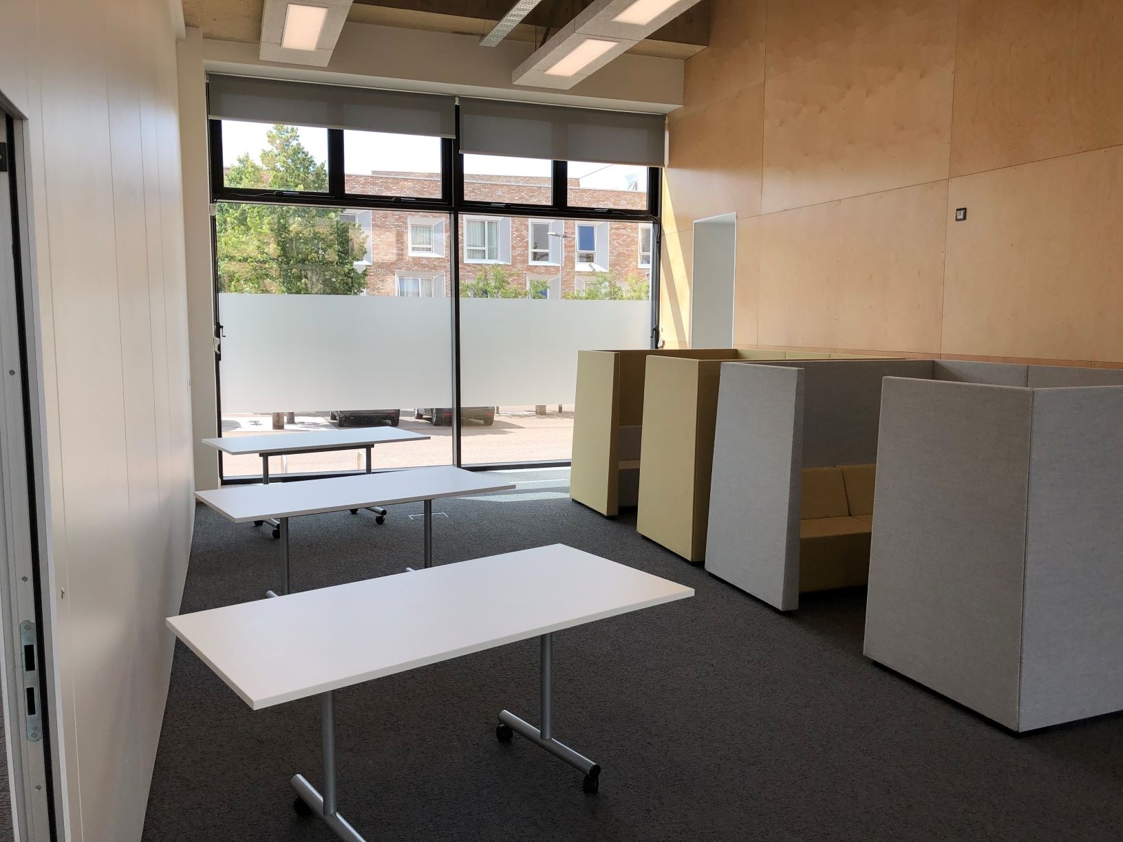 Photograph showing the breakout area of the Multi-Function Space - a large room with three tables.