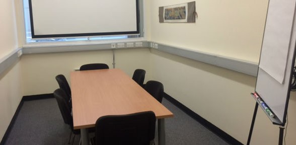 Biomedical Campus Committee Room Photo of the committee room at the Biomedical Campus Postdoc Centre, with 6 chairs around a table