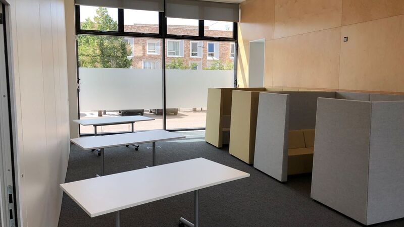 Photograph showing the breakout area of the Multi-Function Space - a large room with three tables.