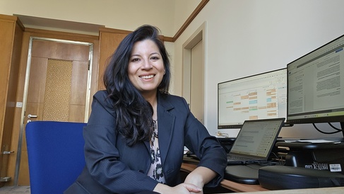Clarissa Rios Rojas sits at her office desk