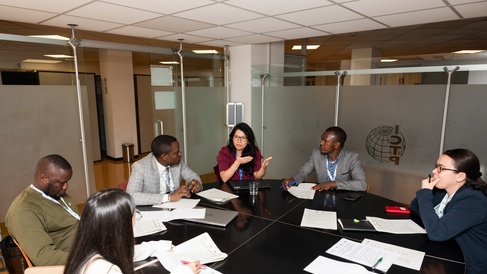 Clarissa Rios Rojas takes part in a meeting around a roundtable