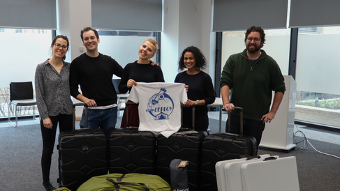 Dilrini stands with her team beside packed away Deploy camping equipment 