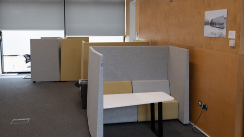 Self contained desks in pods, allowing for private work or taking calls