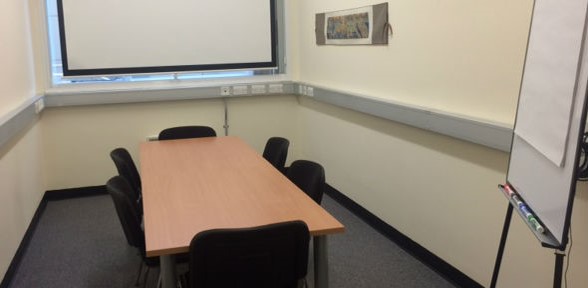 Photo of the committee room at the Biomedical Campus Postdoc Centre, with 6 chairs around a table